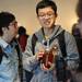 University of Michigan junior Xiaobia Tong, of China, carries a large jar of honey as he shops with friends during the MFarmers' Market at the Duderstadt Center on Thursday. Melanie Maxwell I AnnArbor.com